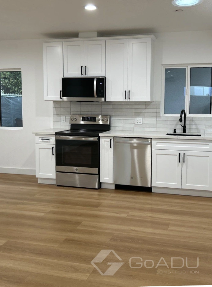 Custom adu kitchens in los angeles with modern appliances and white cabinetry.